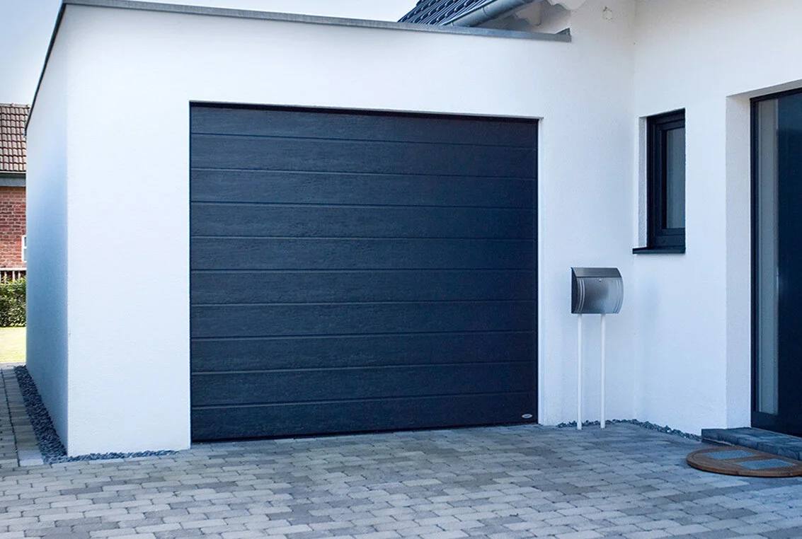 SBI sectional garage door installed on a family home